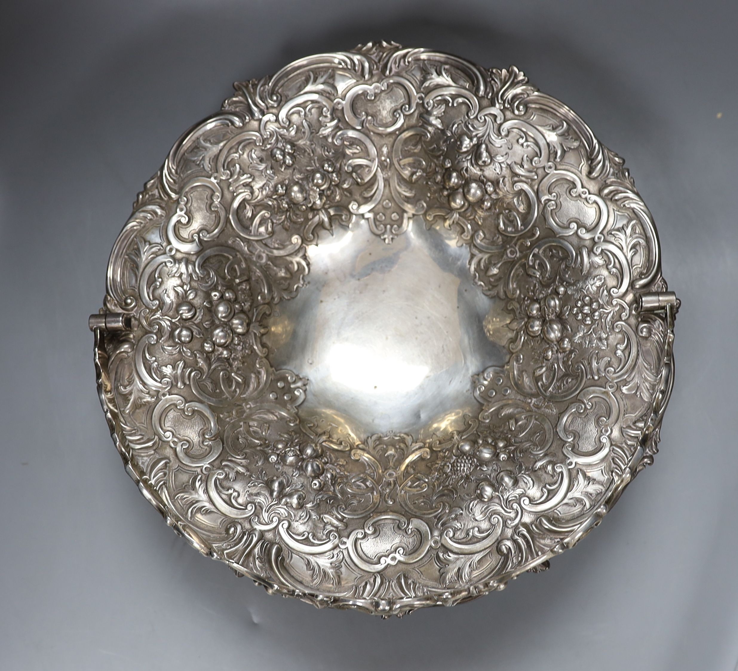 A Victorian Scottish silver fruit basket, embossed with fruit amid scrolls, MS&B, Glasgow, 1861, diameter 32.2cm, 34oz (repairs).